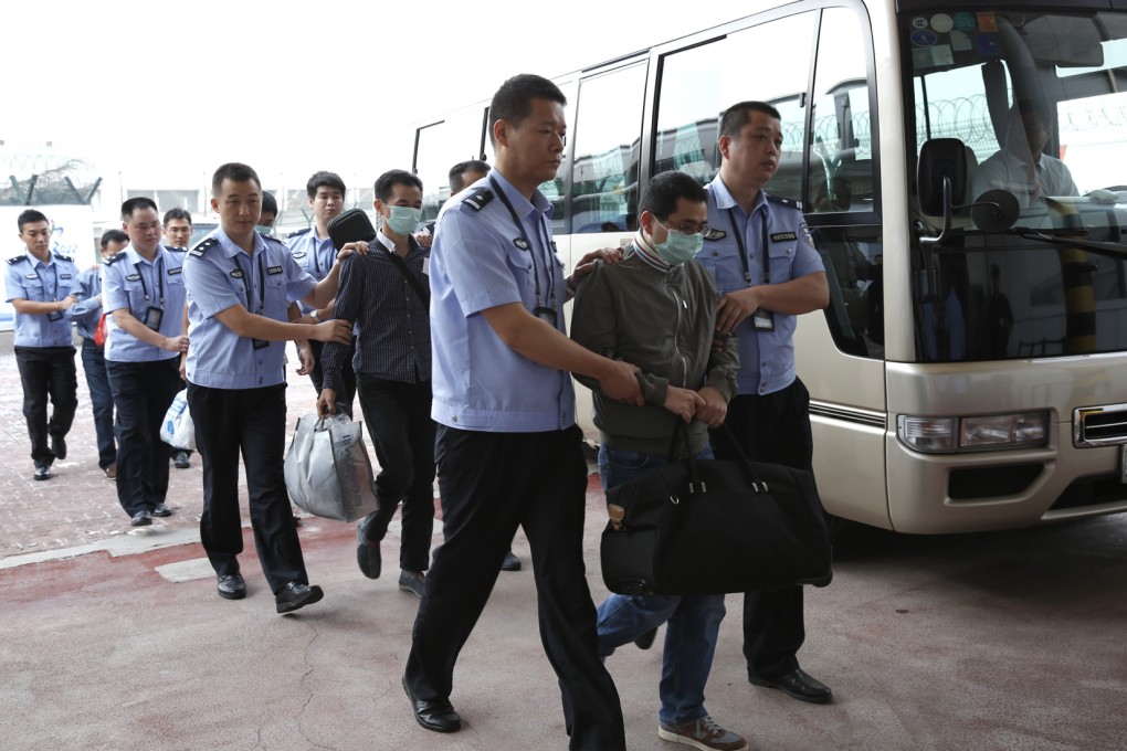 Six fugitives accused of corruption, who had fled to Indonesia, arrive at Beijing airport earlier this month. Photo: Xinhua