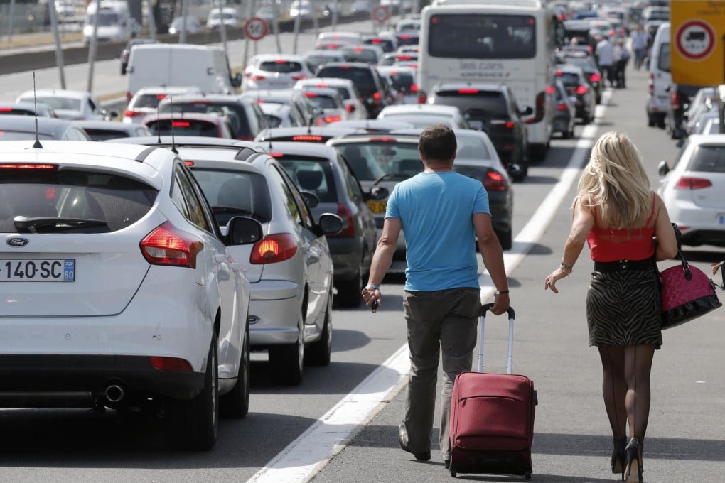 Stranded passengers outside Orly airport as striking taxi drivers block roads in Paris.Photo: Reuters