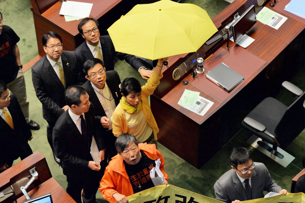 The pan-democrats leave the Legco chamber after voting down the government' electoral reform package. Photo: Kyodo