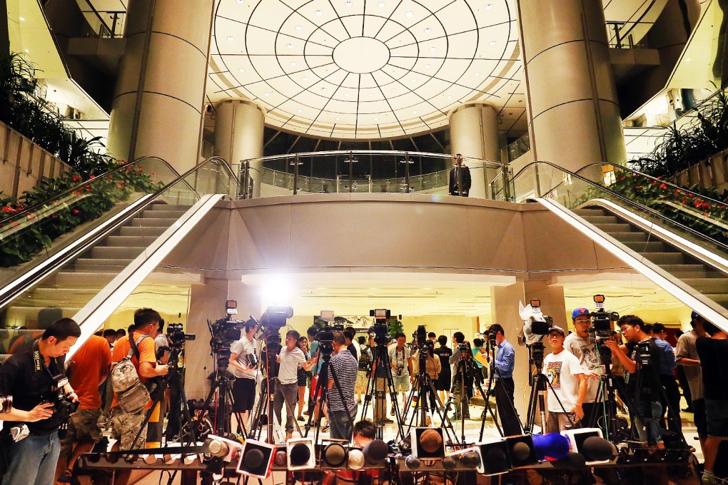 Cameramen and photographers enjoy the rare opportunity to take photos inside central government's liaison office. Photo: Dickson Lee