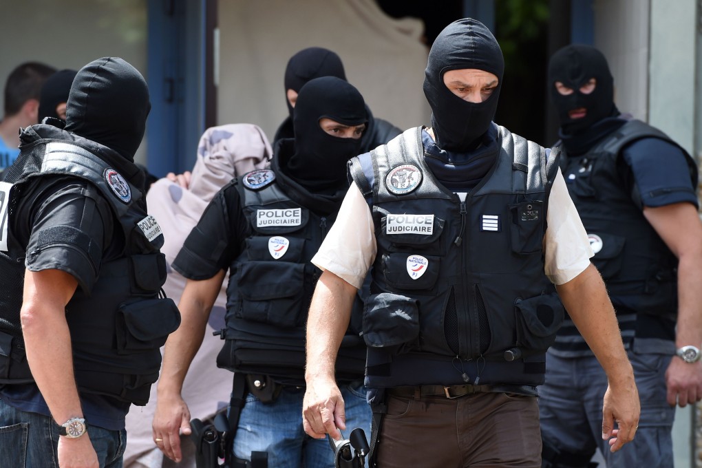 Members of France's Special Forces leave an apartment building after arresting Yassin Salhi. Photo: AFP
