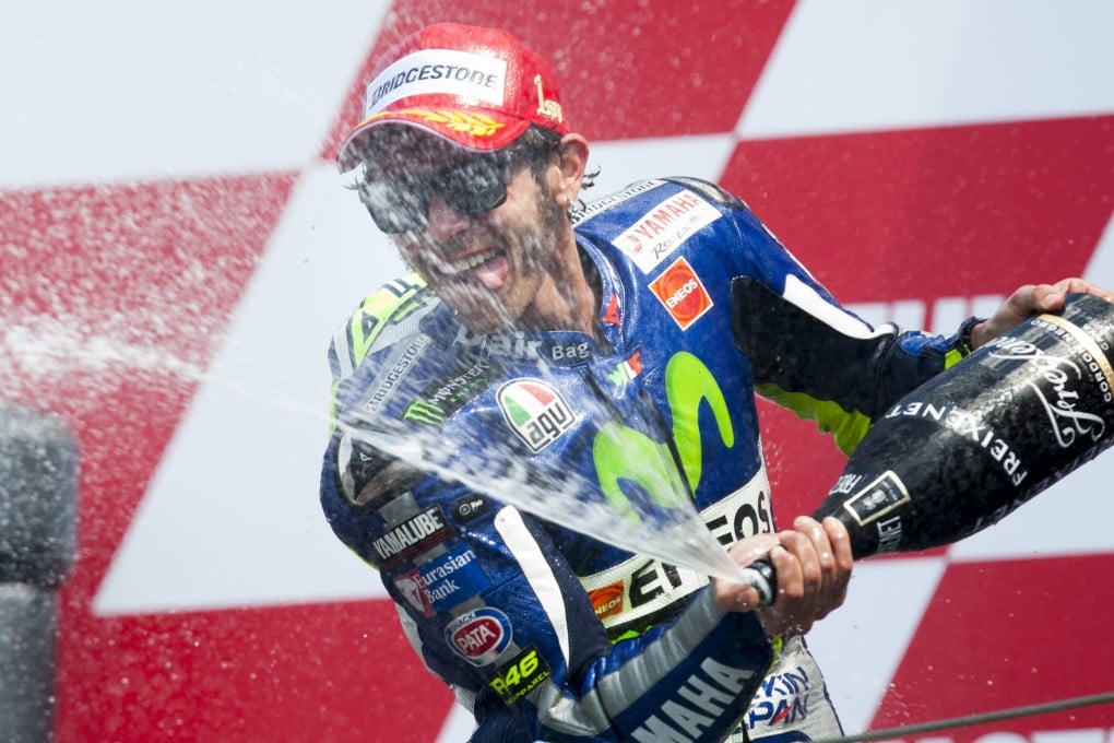 Italian ace Valentino Rossi of Yamaha celebrates on the podium after his victory in Assen. Photo: Reuters