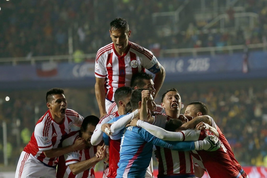 Paraguayan players celebrate teammate Derlis Gonzalez's goal in the penalty shootout. Photo: EPA