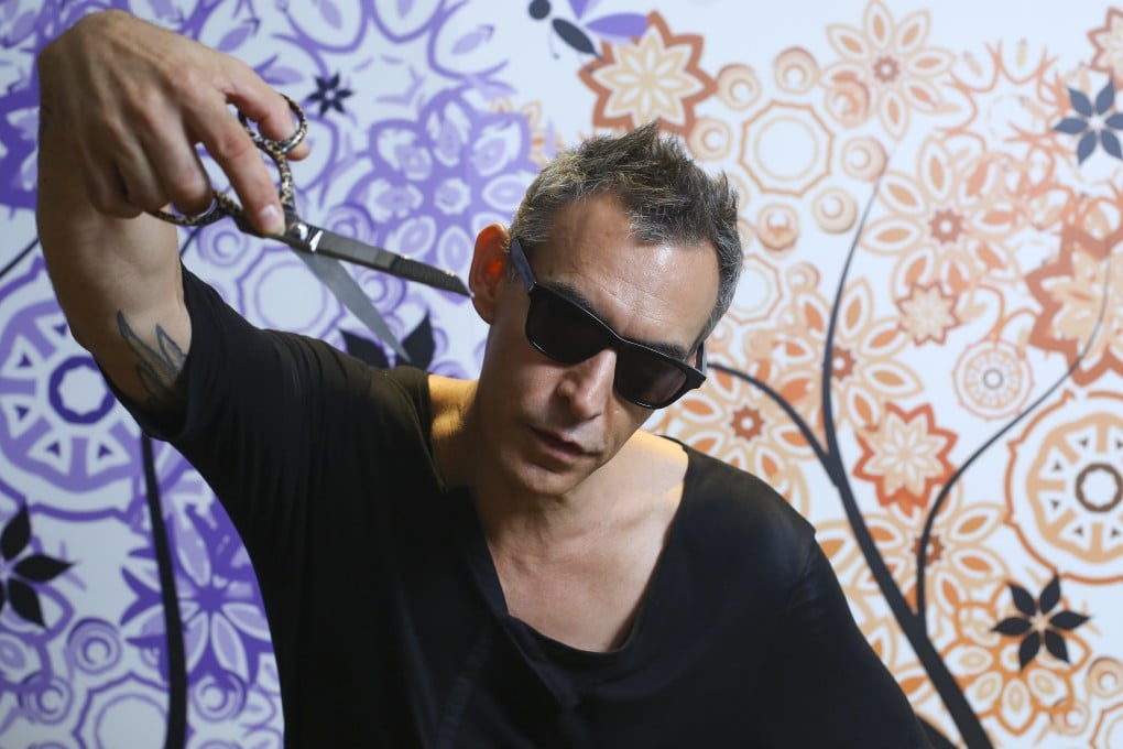 Adam Saaks strikes a pose, scissors in hand.