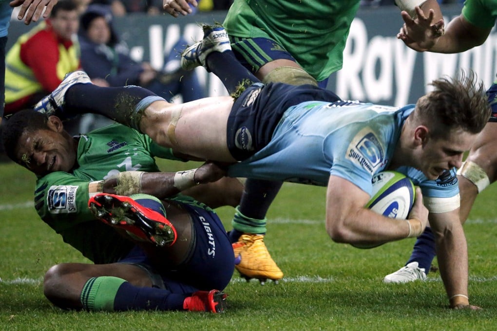 Bernard Foley of the New South Wales Waratahs is tackled by Highlanders winger Waisake Naholo during their Super Rugby semi-final match in Sydney on Saturday. The Highlanders beat the Tahs 35-17. Photo: Reuters