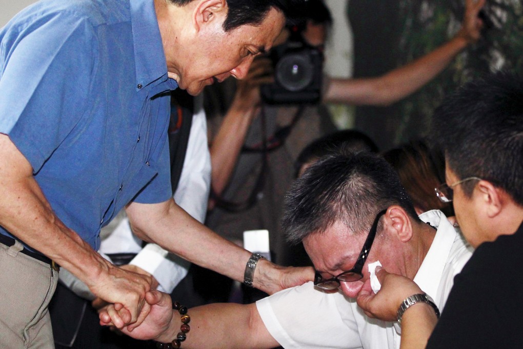 Taiwan's President Ma Ying-jeou, left, meets relatives of people injured in the explosion and fire. Photo: Reuters