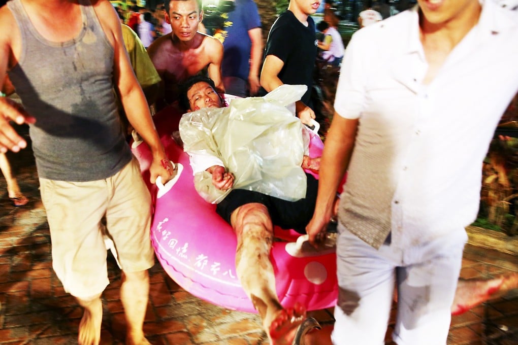 People attend to the fellow injured after the Formosa water park fire. Photo: Reuters