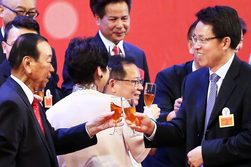 Former Heung Yee Kuk Chairman Lau Wong-fat (left) and Director of Beijing's Liaison Office in Hong Kong Zhang Xiaoming attend the Heung Yee Kuk reception. Photo: Sam Tsang