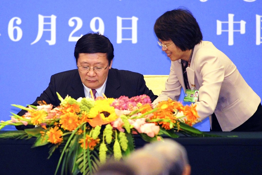 Chinese Finance Minister Lou Jiwei (left) signs the articles of agreement for the China-led Asian Infrastructure Investment Bank at Beijing's Great Hall of the People. Photo: Kyodo