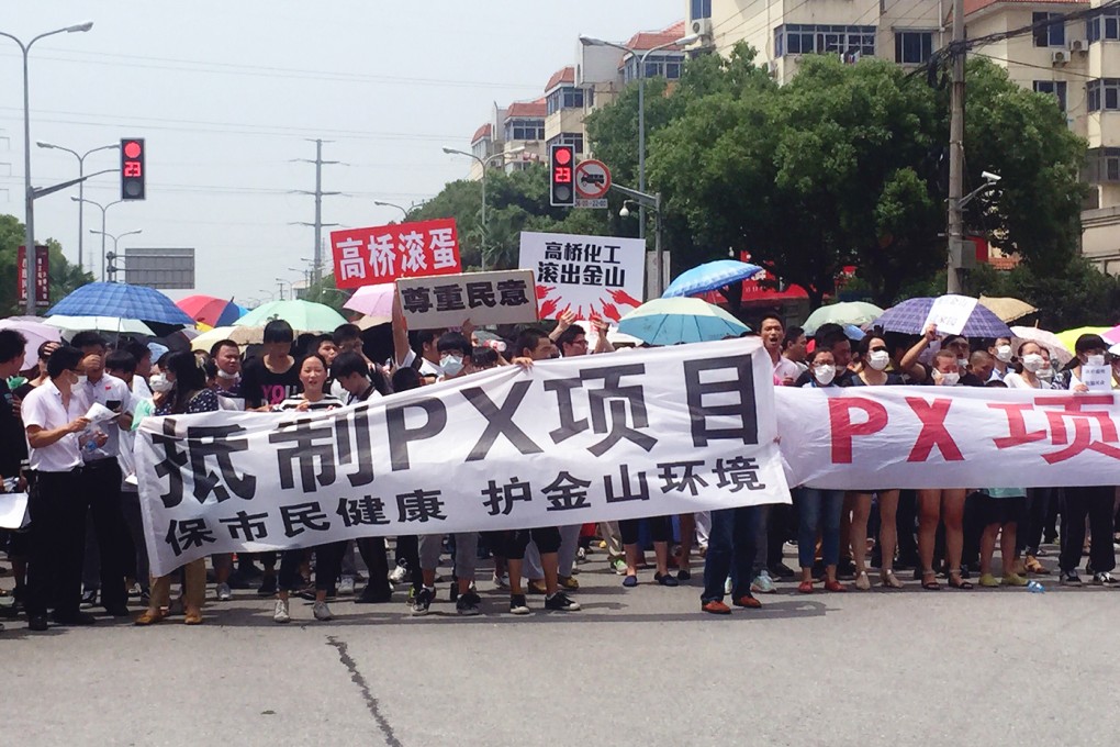 Demonstrators hold banners with slogans to protest against a paraxylene project in Jinshan district in Shanghai last week. Photo: AFP