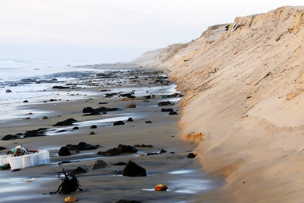 A view shows a damaged sand dune from erosion of the Atlantic Ocean coastline in Montalivet, southwestern France. France's Atlantic Ocean coastline, with its picturesque beaches, sandy between the Gironde estuary and the Adour River, and rocky in the Basque Country, diminishes several meters every year. Photo: Reuters