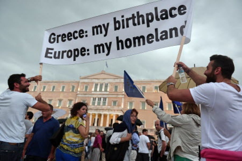 Demonstrators express their support of the euro in front of the Greek Parliament Building in Athens. Photo: AFP