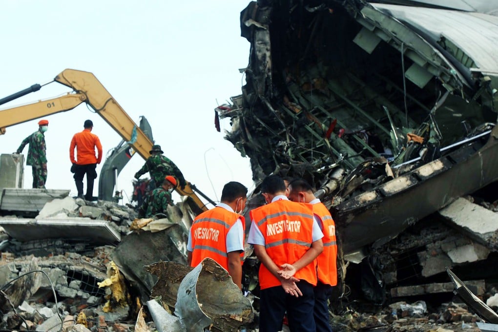 Indonesian military investigators inspect the wreckage of the crashed C-130 military airplane at the crash site in Medan, North Sumatra. Photo: EPA