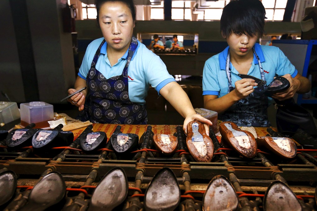 Workers at a shoe factory in Wenzhou in eastern Zhejiang province. Firms cut staff levels last month at the sharpest pace since February 2009, according to the survey. Photo: Reuters