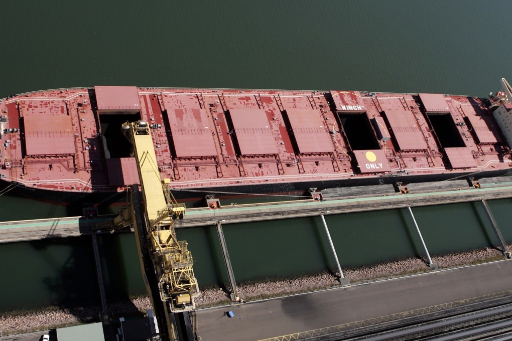 Coal is loaded on a ship in Australia as the country tries to cope with a 'new normal' in its commodity exports of low prices and strong volume. Photo: Reuters
