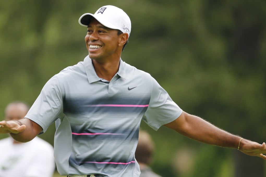 Tiger Woods shares a laugh with friends and tournament officials  during the pro-am at the Greenbrier Classic tournament. Photos: AP