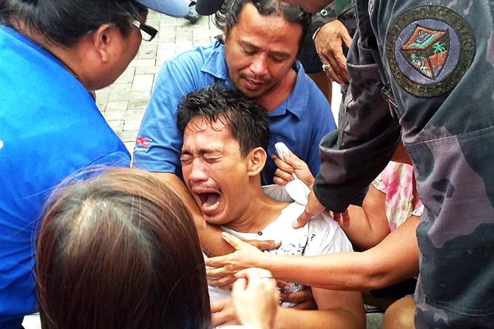 A survivor of a passenger ferry that capsized in rough waters cries after arriving at the pier in Ormoc City, central Philippines. Photo: AFP