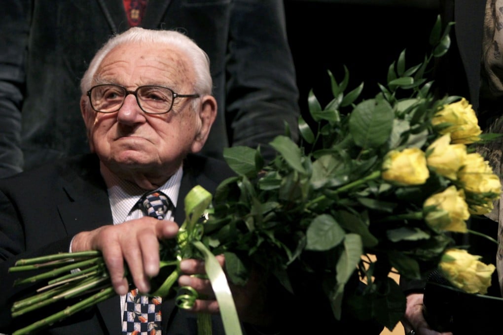 Nicholas Winton, then aged 101, holds flowers while sitting on a stage after the premiere of the movie "Nicky's Family" which is based on his life story in Prague, in this file photograph dated January 20, 2011. Photo: Reuters
