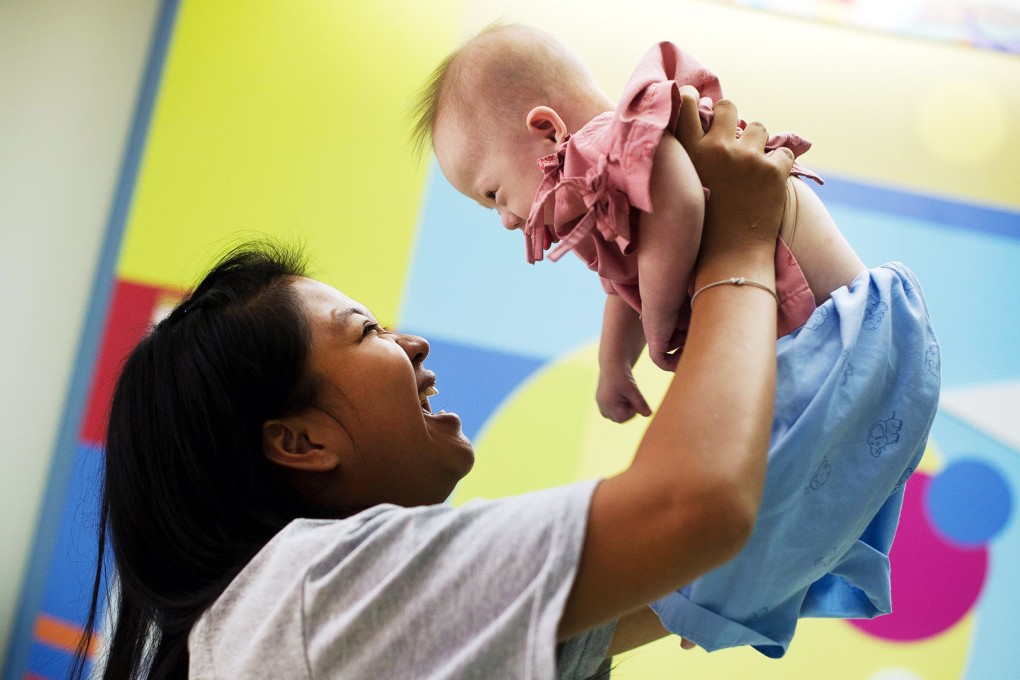 Thai surrogate mother Pattaramon Chanbua (left) with her baby Gammy at the Samitivej hospital in Sriracha district, Chonburi province. Photo: AFP