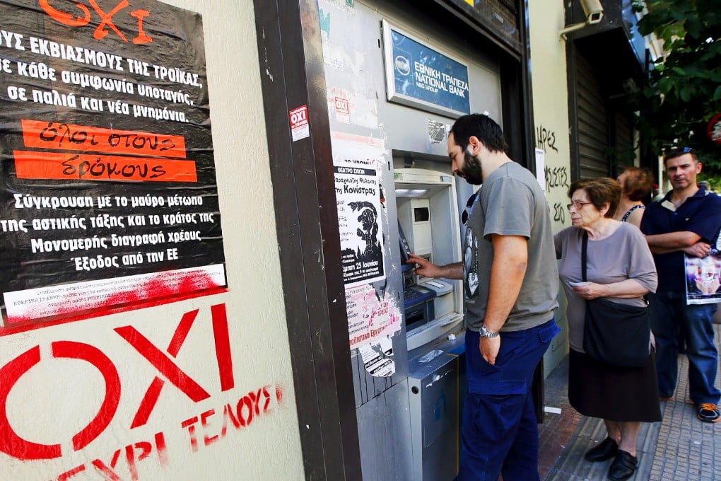 Referendum campaign posters that reads "No" in Greek  as people line up at an ATM outside a National Bank branch in Athens. Photo: Reuters