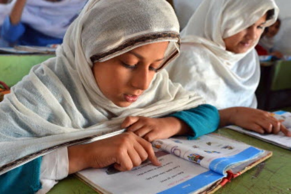 These girls studying at a government school in Peshawar symbolise Pakistan's commitment to educational reform. Photo: AFP