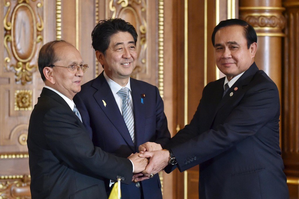 Japan's Shinzo Abe (centre) shakes hands with Myanmar President Thein Sein (left) and Thai premier Prayuth Chan-ocha. Photo: Reuters