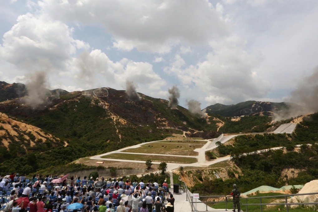 Guests and local media watched the PLA Hong Kong Garrison conduct a military exercise against 'terrorists' at Castle Peak firing range at Tuen Mun. Photo: Felix Wong