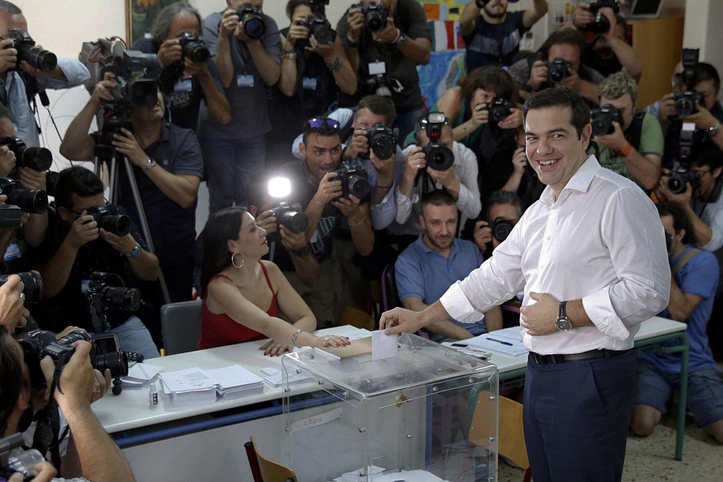 Prime Minister Alexis Tsipras votes at a polling station in Athens, saying a 'No' would give Greeks dignity. But some pensioners, angry at being unable to get money, were not so sure. Photos: Reuters