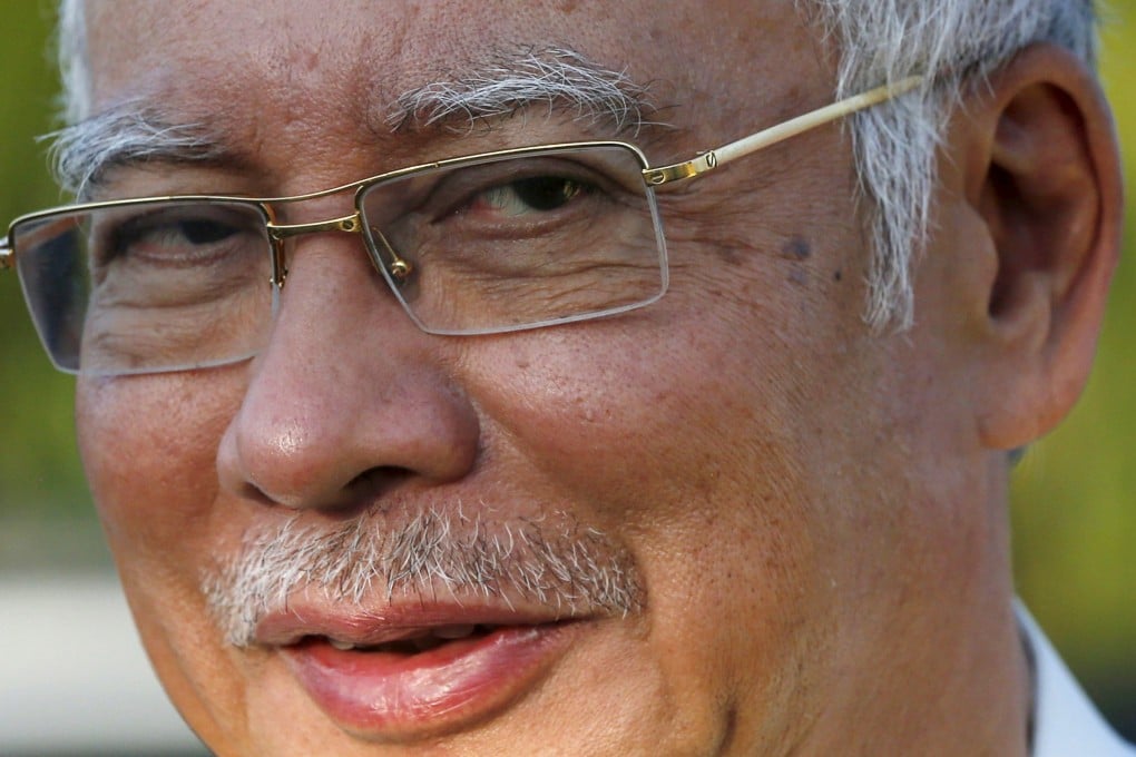 Malaysia's Prime Minister Najib Razak's office says he plans to sue The Wall Street Journal over the report over funds allegedly funnelled from a debt-strapped state investment body to his bank accounts. Photo: Reuters