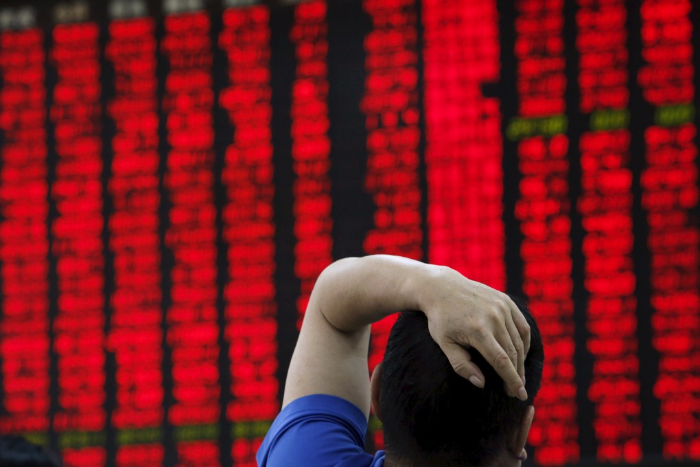 A man watches a board showing stock prices at a brokerage office in Beijing. Photo: Reuters