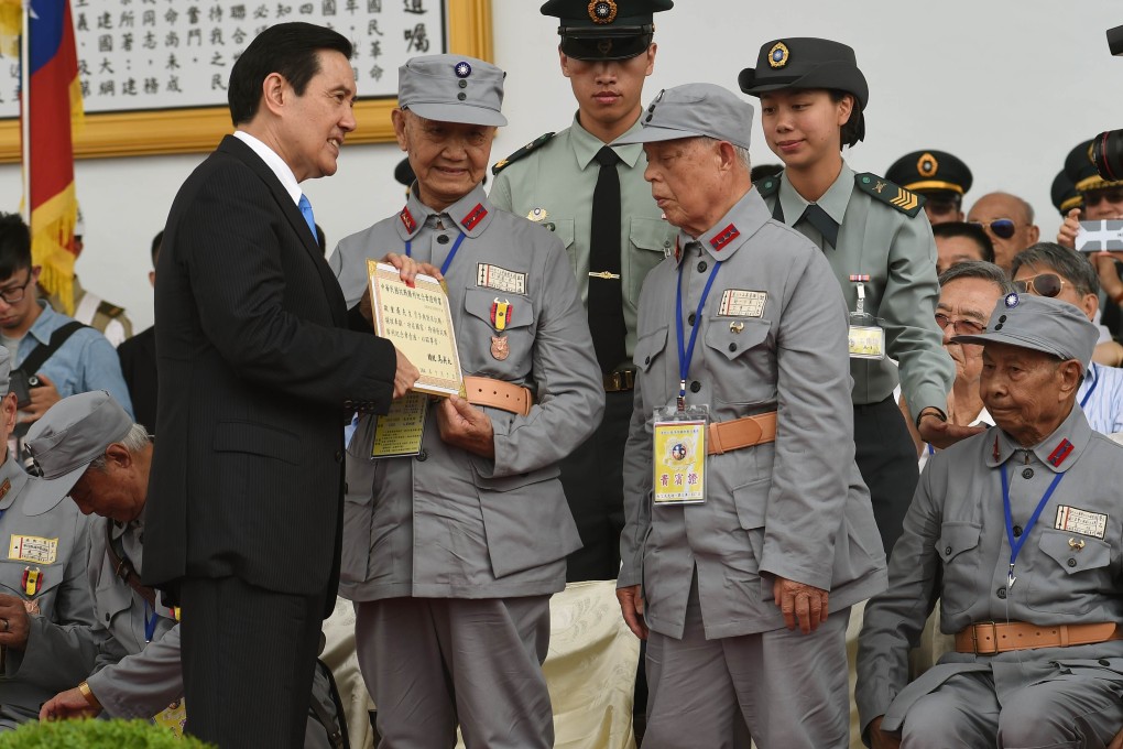 A veteran receives a certificate from President Ma Ying-jeou at the 70th anniversary parade. Photo: AFP