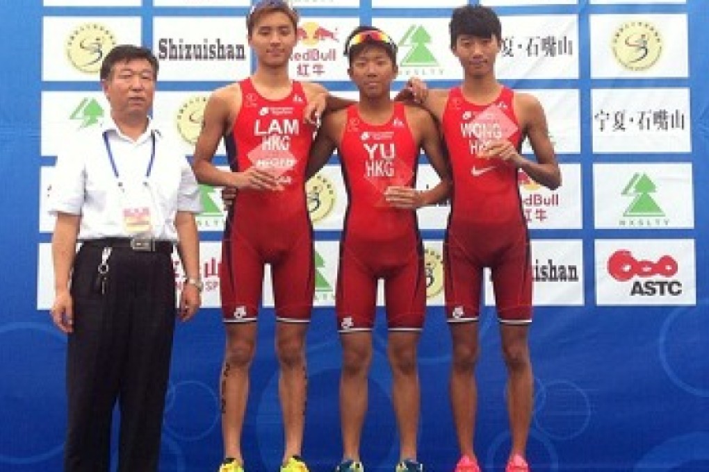 Hong Kong's Mark Yu is flanked by teammates Michael Lam (left) and Wong Tsz-to on the podium after their clean sweep of the elite junior race at the Shizuishan ASTC Triathlon Premium Asian Cup event. Photo: SCMP Pictures