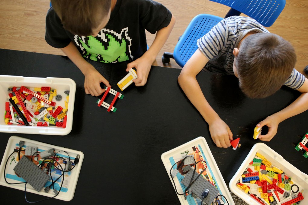 William Lerner, left, and William Kaegi learn coding skills while playing with blocks during a sports/coding summer camp in the US state of Illinois. Photo: Antonio Perez