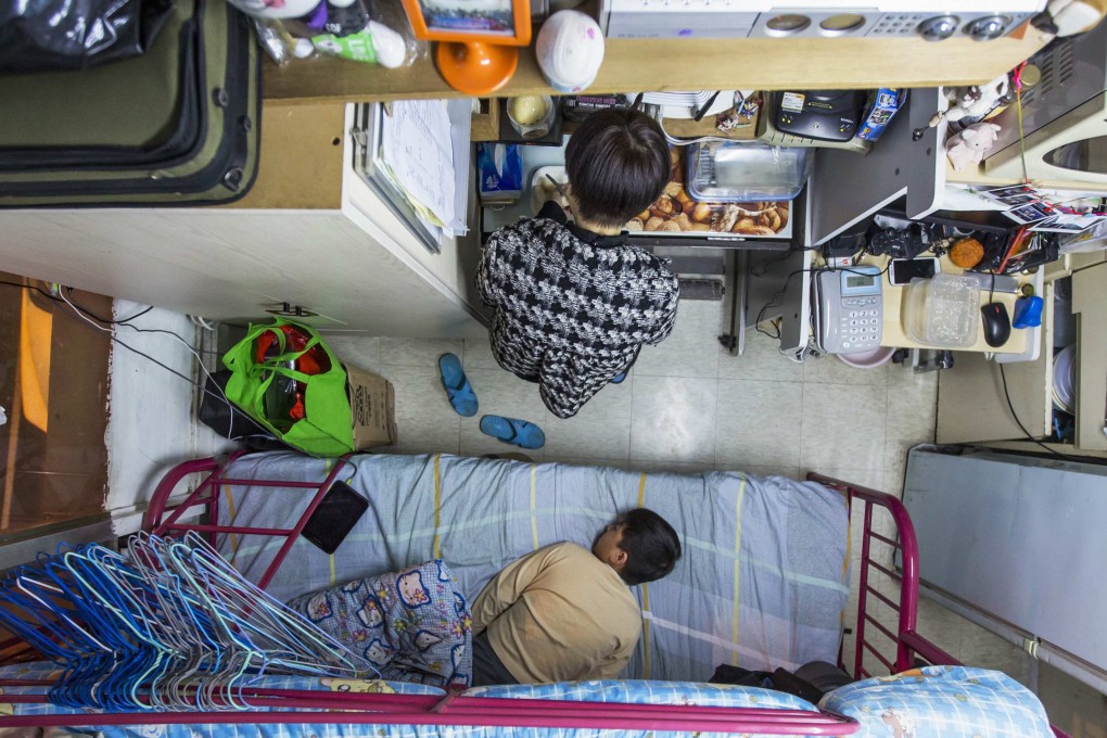 A woman and her son are seen in their 60-square-foot sub-divided flat in Hong Kong. Photo: Reuters