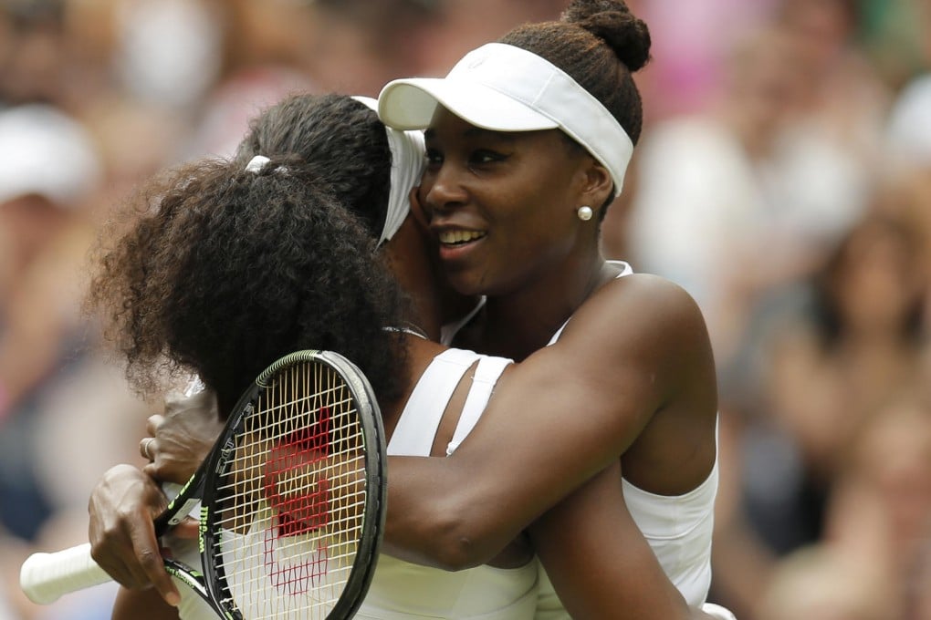 The Williams sisters give each other a big hug after Serena easily overcame sibling Venus to reach the quarter-finals, firing 10 aces in their match. Photo: Reuters