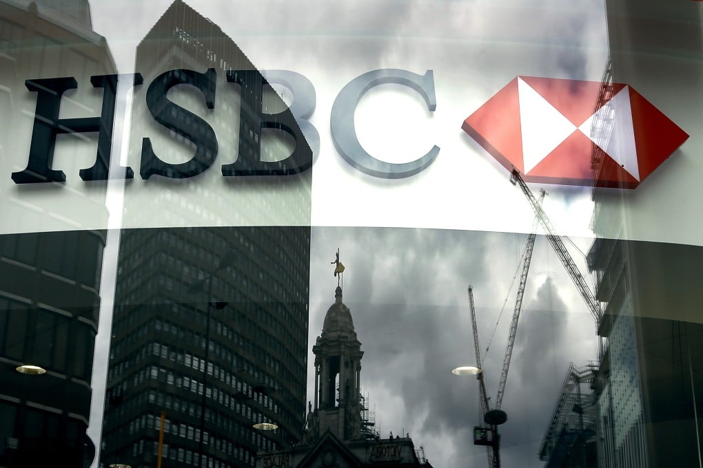 The HSBC logo is seen through a window in London as British banks ask the government to phase out an industry levy. Photo: AP