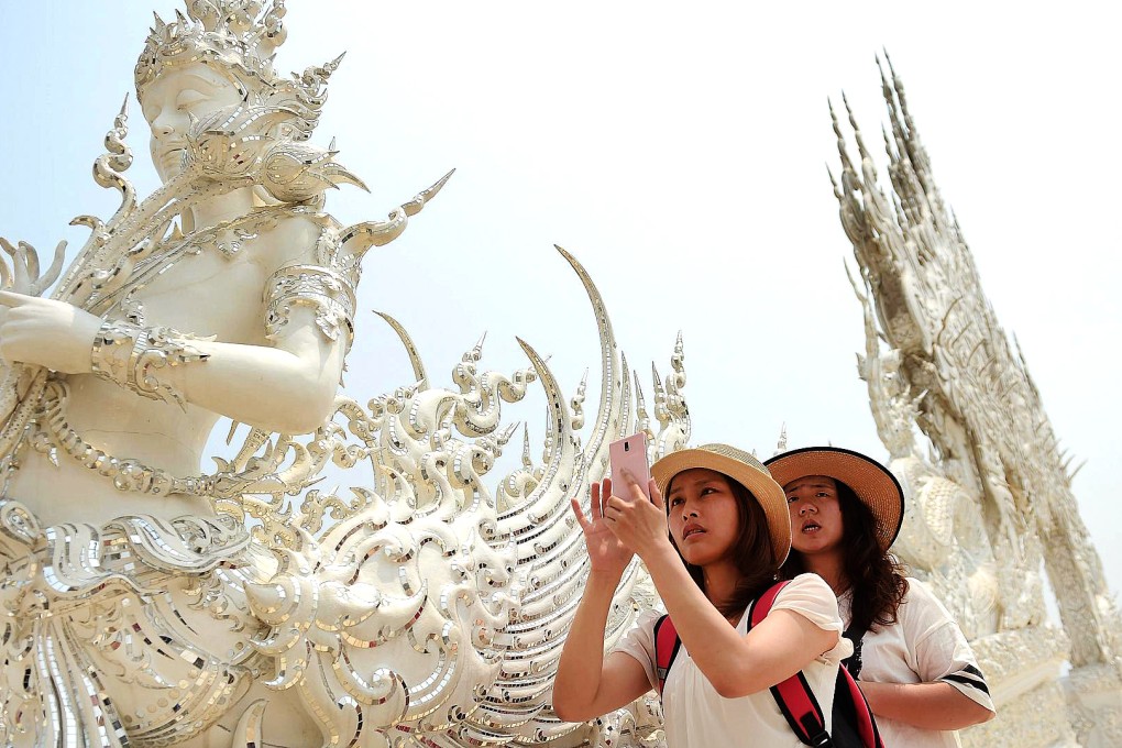 Tourists visit the White Temple, where the owner complained about the state of the toilets after a recent visit by a Chinese group. Photo: AFP
