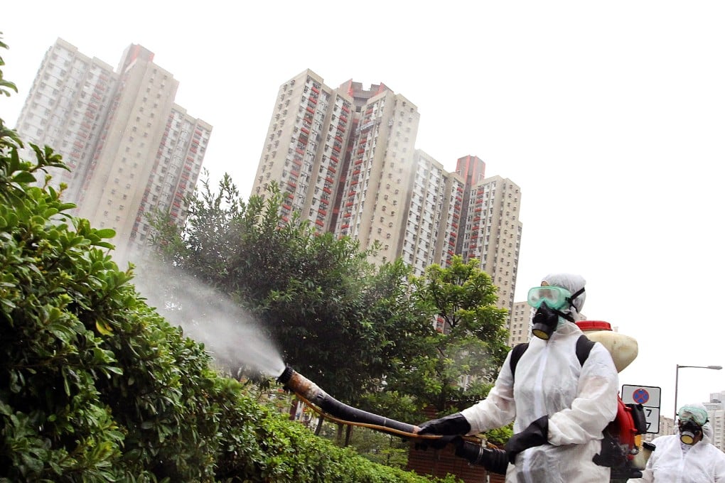 Hong Kong Food and Environmental Hygiene Department workers spray poison to kill mosquitoes that may carry dengue fever. Mosquitno is targeting the city with its nano-tech based repellent. Photo: Edward Wong