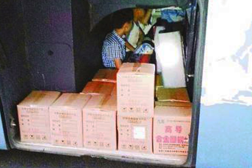 The bus driver cut a hatch in the floor beneath a bunk on the long-distance bus to allow extra passengers to ride in the baggage compartment. SCMP Pictures