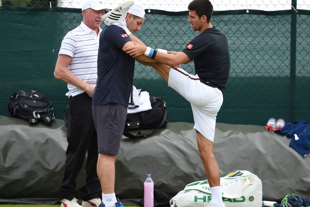 Novak Djokovic limbers up before a session on court. Photo: Reuters