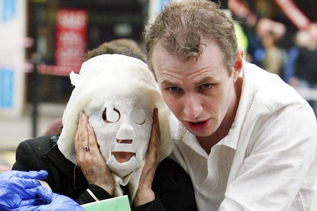 Ten years ago: an injured Tube passenger is escorted away. Photo: AP
