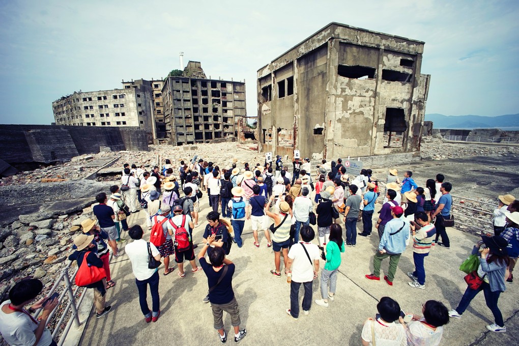 Tourists visit a part of Hashima Island, commonly known as Gunkanjima, off Nagasaki in southern Japan. The island was one of 23 old industrial facilities seeking Unesco's recognition as a world heritage site. Photo: AP