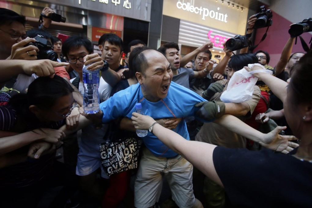 Political confrontations like this one during the Umbrella Movement in October have to stop. Photo: EPA