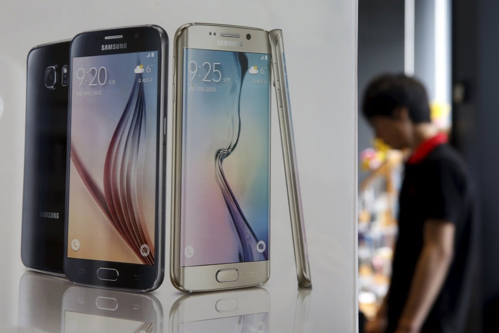 A man stands next to a banner promoting Samsung Electronics' smartphone Galaxy 6 at a store in Seoul. Photo: Reuters