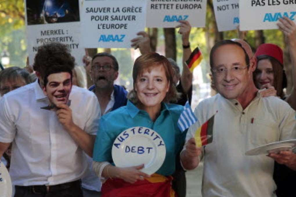 Demonstrators in Paris holding masks of (from left) Greek Prime Minister Alexis Tsipras, German Chancellor Angela Merkel and French President Francois Hollande express their opposition to bailing Greece out of debt on Monday. Photo: AFP