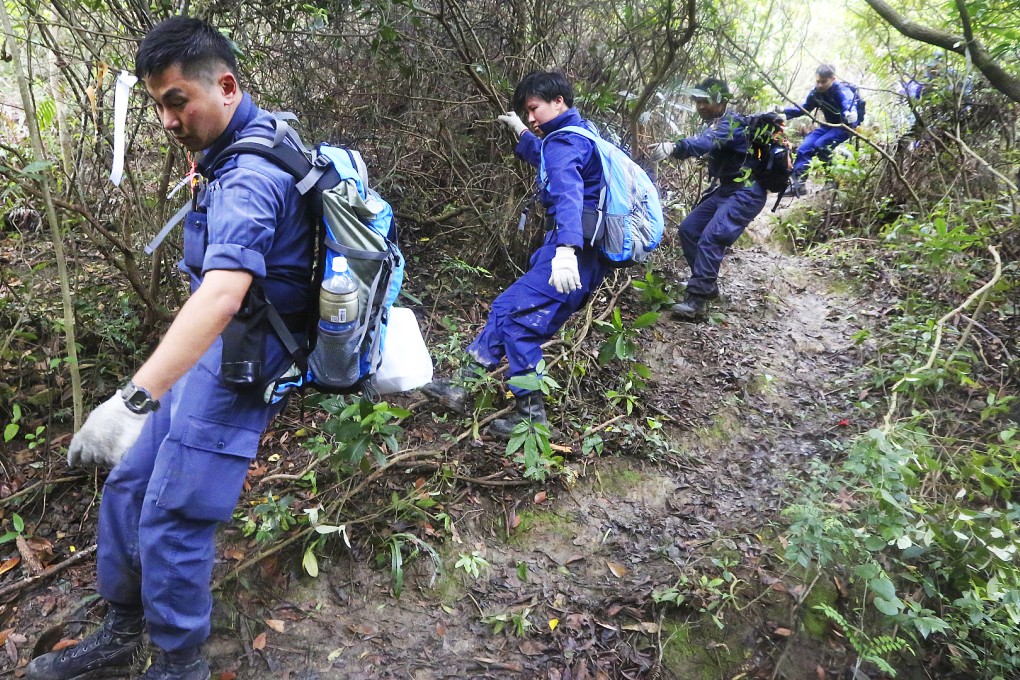 Police search around the Pik Uk Prison area along Clear Water Bay Road in May in an attempt to locate a cave where kidnappers are believed to have hidden Queenie Law. Photo: Felix Wong