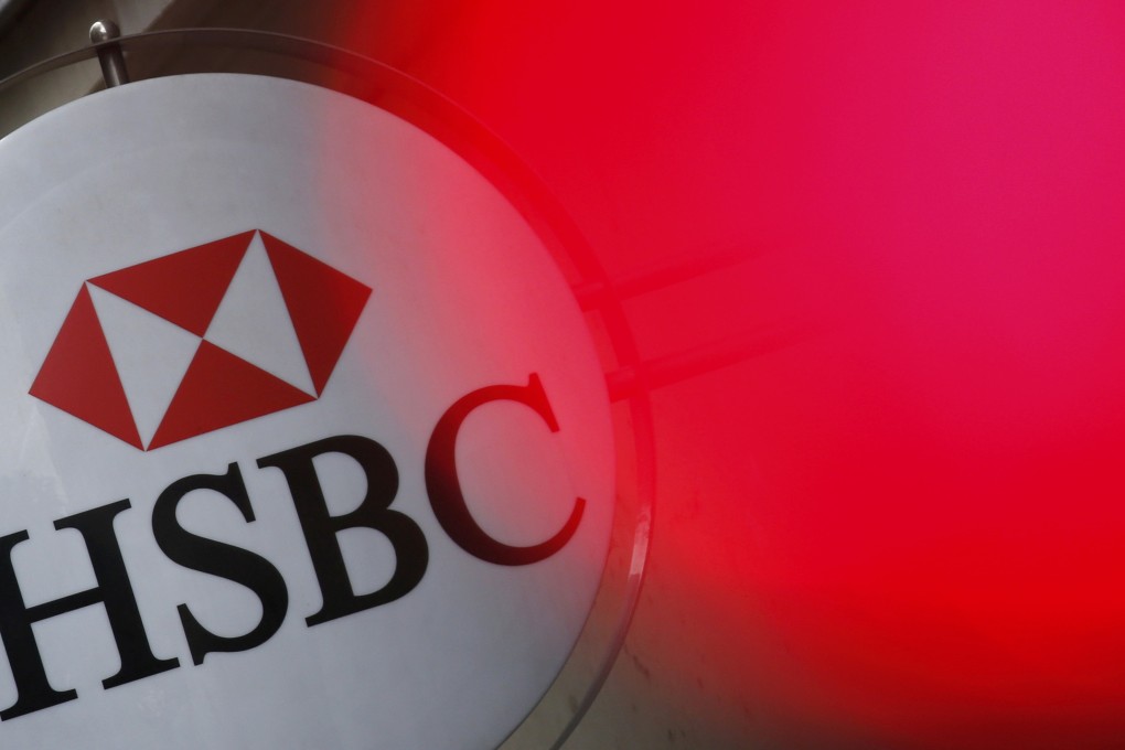 An HSBC bank logo is illuminated by a traffic light in France as global lenders may find it would better to get smaller in a post-2008 crisis environment. Photo: Reuters