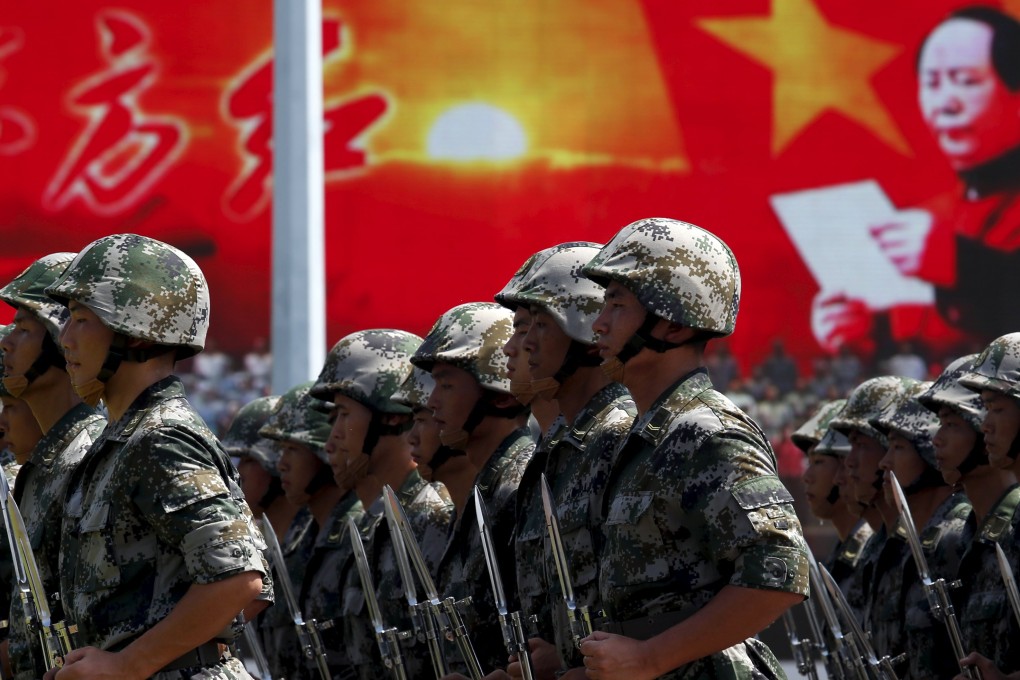 People's Liberation Army soldiers stationed in Hong Kong take part in a ceremony to mark the 18th anniversary of the handover on July 1. Photo: Reuters