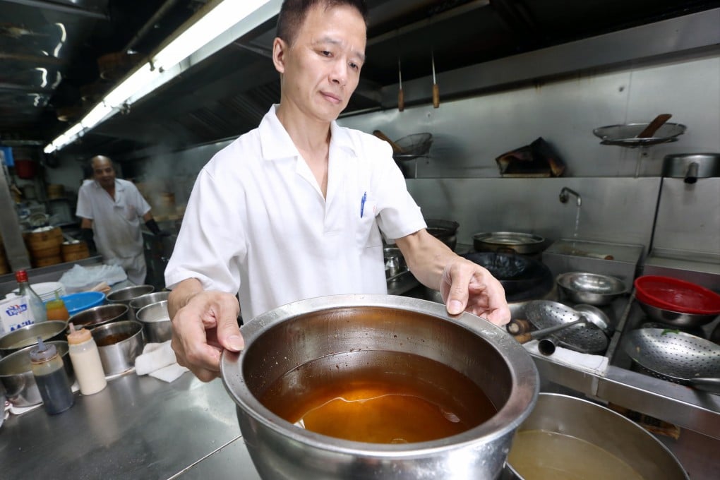 Chef Hung Cheung-chiu with waste oil. Photo: Sam Tsang