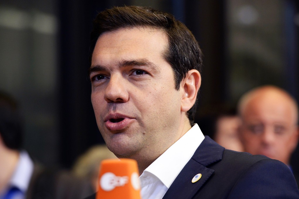 Greek Prime Minister Alexis Tsipras answers journalists' questions as he leaves the euro zone summit at the European Council headquarters in Brussels. Photo: AFP